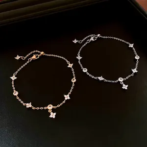 Luxurious gold and silver four-leaf flower bracelets with zircon on black leather