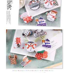 Detailed view of festive Christmas hair claws featuring snowman and gingerbread man designs