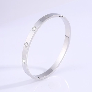 Macro view of silver four-leaf clover bracelet with zircon inlay and hinge detail