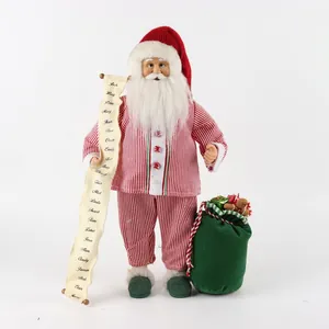 Detail of fabric Santa figure holding a list scroll with green gift bag and striped pajamas