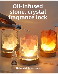 Macro view of crystal stones in glass cups on a warm glowing wooden base with essential oil
