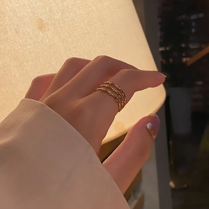 Detailed view of women wearing a triple-layer bamboo texture 18k gold stainless steel ring