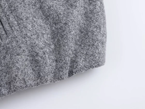 Macro shot of premium grey textured wool fabric on a modern bomber jacket detail