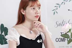 Minimalist silver round hollow geometric pendant necklace worn by a model in a cozy setting