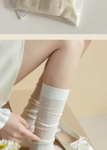 Detail of creamy white cotton ballet style mesh socks with packaging and on-model view