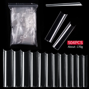 Macro detail of 504pcs transparent XXL C-curve nail tips across twelve distinct sizes