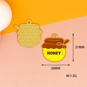 Detailed view of enamel honey pot pendant showing front design and back texture