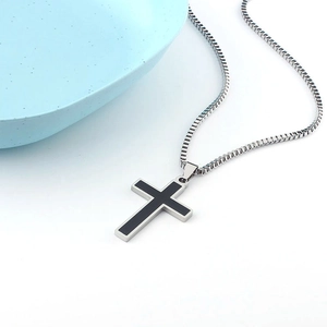Detail of black cross pendant on hip hop titanium steel necklace with elegant blue plate