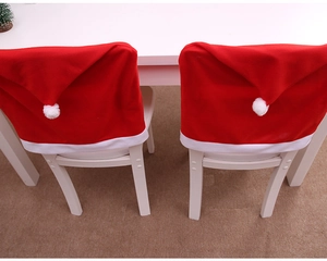 Detail of red and white velvet Christmas hat chair covers for festive table decoration