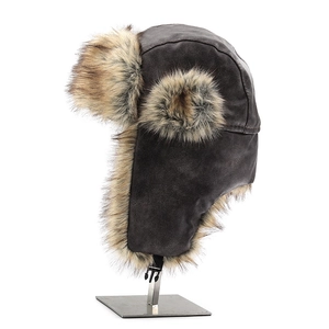 Close-up of vintage brown leather trapper hat with faux fur lining and earflaps