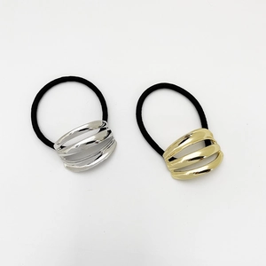 Close-up of metallic streamlined hair ties in gold and silver finish with high-stretch bands