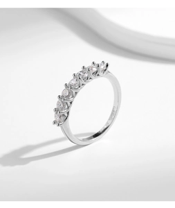 Macro detail of silver ring featuring seven round cut stones in a classic row setting