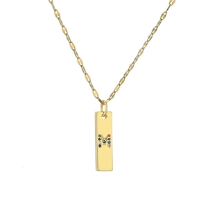 Detailed macro view of a gold-plated rectangular pendant with a colorful stone-set letter M
