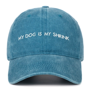 Close-up of MY DOG IS MY SHRINK white embroidery on washed indigo cotton baseball cap