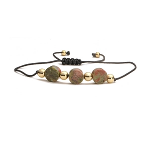 Macro detail of handmade adjustable bracelet with natural unakite and gold beads