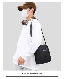 Side view of men's waterproof crossbody bag on model showing size and fit for travel