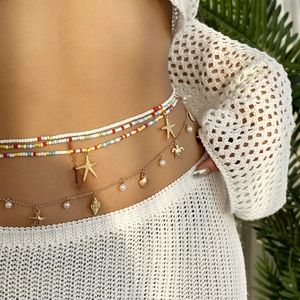 Bohemian multilayer waist chain with colorful beads, starfish charms and pearls on a model