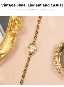 Macro detail of elegant vintage gold quartz watch on soft pink silk background