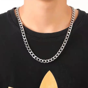 Silver stainless steel NK chain necklace worn on model neck for a stylish hiphop look