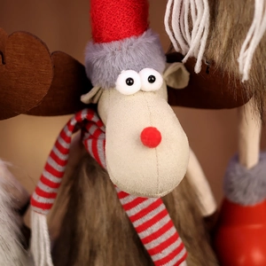 Close-up of plush Christmas reindeer toy with knit hat and textured faux fur details