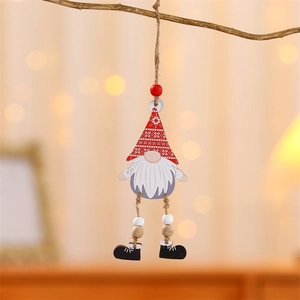 Wooden Christmas gnome ornaments with dangling legs hanging on a rustic festive tree branch