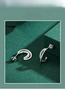 Macro shot of S925 sterling silver stud earring showing micro-inlaid stones and hallmark