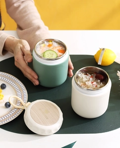 Close-up of 304 stainless steel food jars with wood grain lids and silicone handles