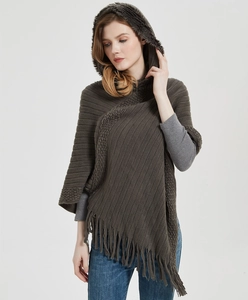 Detail of dark brown knitted hooded poncho wrap with elegant fringe tassels for women