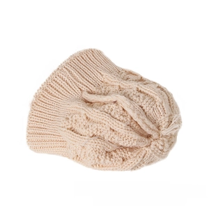 Detailed close-up of light beige chunky cable knit pattern on a winter baby beanie