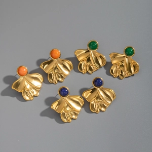 Detailed shot of three pairs of vintage gold flower stud earrings with colorful gemstones