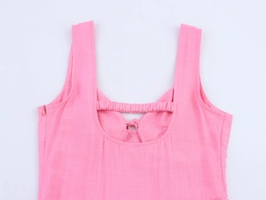 Detail of pink cotton maxi dress featuring back cutout and elastic smocked texture