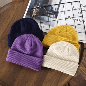 Unisex ribbed knit beanies in navy, purple, yellow, and beige for winter warmth