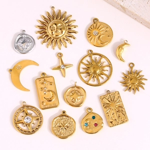 Macro view of gold celestial pendants with sun, moon and star designs with rhinestones