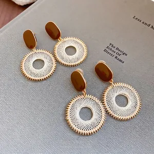Bohemian grid pattern circle earrings with brown oval accents and golden thread details