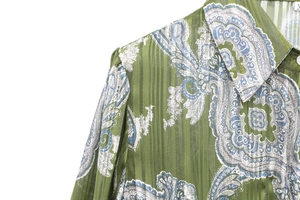 Detail of green paisley print shirt featuring vertical stripe texture and mandarin collar
