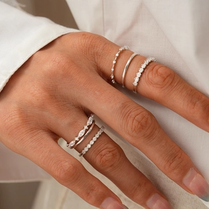Detail of silver layered rings set featuring marquise cut zircon and pavé stones