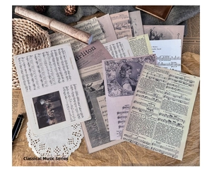 Close-up of vintage music themed scrapbooking papers with musical notes and scrolls
