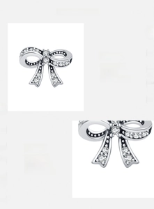 Macro detail of s925 silver bow stud earrings with sparkling hand-set 5A cubic zirconia