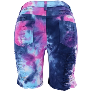 Detail of high waist tie-dye denim shorts featuring ripped holes and frayed hem back view