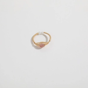 Detail of handmade wire wrapped 14K gold plated ring with round pink strawberry crystal