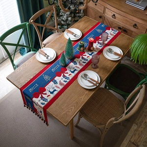 Christmas table runner with reindeer and Merry Christmas print and tassel accents