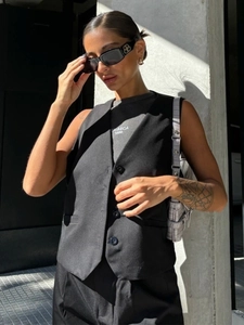 Detail of a black V-neck vest and gray Tribeca printed T-shirt set in an urban street style