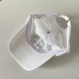 Interior detail of a breathable white quick-dry nylon baseball cap with soft top