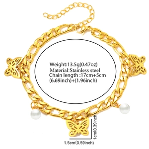 Detailed macro view of gold-plated butterfly charm and white pearl on stainless steel chain
