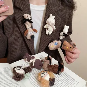 Cute cartoon flocked bear and kitty brooch pinned on a vintage brown tweed suit jacket