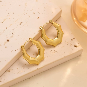 Détail de créoles en acier titane plaqué or 18 carats avec design bambou octogonal