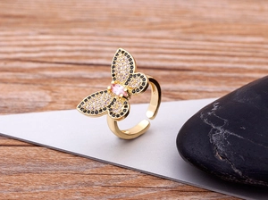 Detailed view of adjustable butterfly ring with pink and black zircon in 18K gold plating