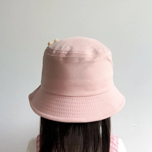 Rear view of a pink cotton children fisherman hat showing fabric texture and fit