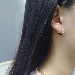 Close-up of elegant gold S925 sterling silver heart hoop earrings worn by a model