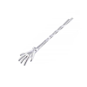 Close-up of a silver skeleton hand hair clip with metallic wave shape design